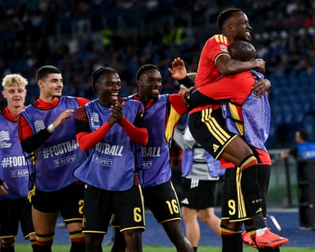 Dodi Lukebakio celebrates with the Belgium substitutes after scoring against Italy in Rome.