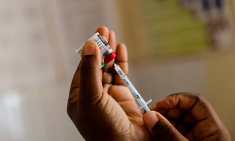 A nurse fills a syringe with an earlier type of malaria vaccine in Kenya in 2022.