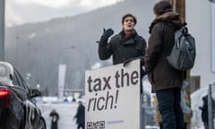 Marlene Engelhorn stands with a placard reading ‘Tax the rich!"’