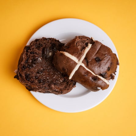 A Waitrose No 1 Belgian chocolate hot cross bun, sliced, toasted and buttered, on a white plate