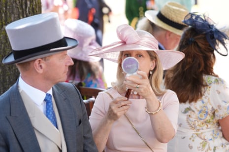 A racegoer puts the finishing touches to her make-up on day two of Royal Ascot.