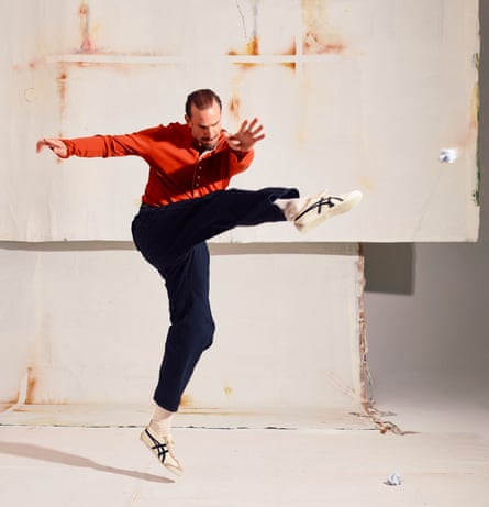Actor Joseph Fiennes kicking a rolled-up piece of paper