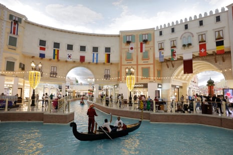 Motor-powered gondolas for hire on the fake canal with a fake sky painted on the roof inside the Villagio Mall, which is decked out with World Cup flags.