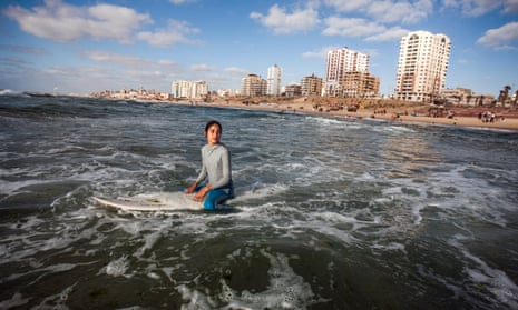 Sabah Abu Ghanim waits for a wave in Gaza City.