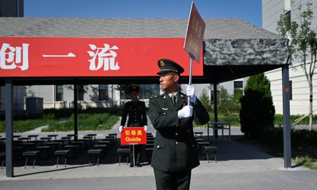A Chinese soldier holds a signboard to guide journalists during a tour arranged for the media by the press centre in charge of celebrating the 70th anniversary of the country’s founding