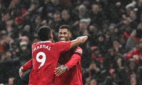 Martial celebrates with Rashford in the rain