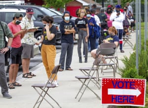 Voters wait in a line that stretched around the Metropolitan Library in Atlanta, Georgia on 9 June.