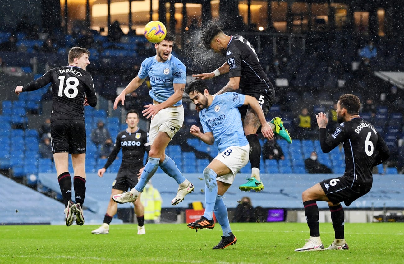 Aston Villa’s Tyrone Mings in action with Manchester City’s Ruben Dias and Ilkay Gundogan.