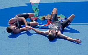 Alistair Brownlee, left, and Jonny Brownlee after they finished 1st and 2nd in the mens triathlon on Copacabana beach during day thirteen of the 2016 Olympics in Rio de Janiero