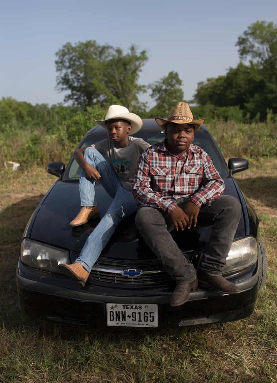 Xavier McNeal and James Wilborn sit on a car at the trail ride.