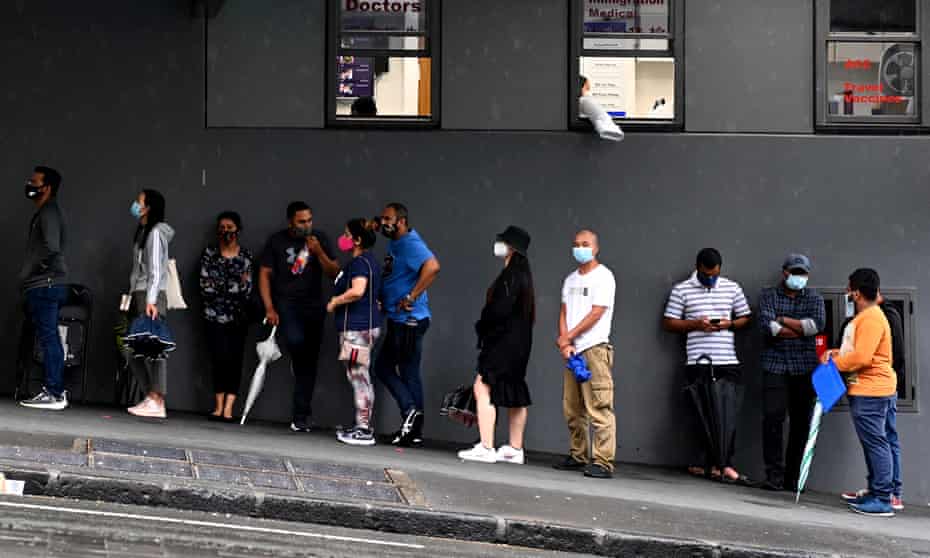 Auckland residents wait in line for Covid tests.