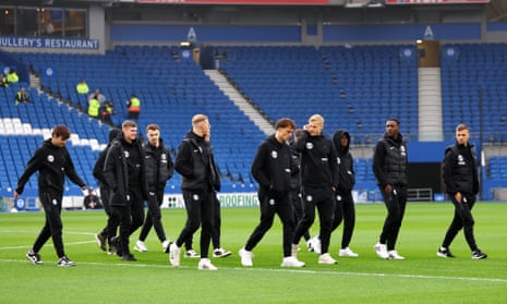 Brighton’s players inspect the pitch ahead of kick-off.