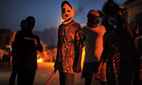 A masked anti-government protester is seen during clashes with police in Lomé in 2013