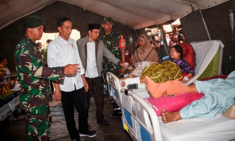 INDONESIA-QUAKE<br>Indonesia’s President Joko Widodo (2nd L) visits injured earthquake survivors at a temporary hospital in North Lombok on West Nusa Tenggara province on August 13, 2018. - The death toll from an earthquake on the Indonesian island of Lombok has topped 400, authorities said, as bodies were still being recovered from the ruins of destroyed buildings. (Photo by STR / AFP)STR/AFP/Getty Images