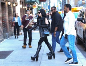 Dressed all in black and with platform boots, the singer Lady Gaga arrives with two minders for her appearance on the Late Show with Stephen Colbert
