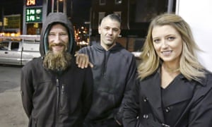 Johnny Bobbitt Jr, left, Kate McClure, right, and McClure’s boyfriend, Mark D’Amico, pose at a Citgo station in Philadelphia. 