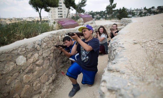 Israeli youths holding mock guns relive the battle for Jerusalem during the six day war in 1967