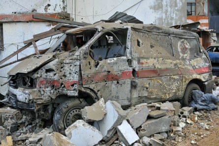 An ambulance crushed by rubble.