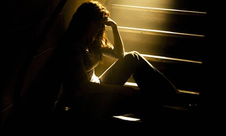 Teenage girl in shadows on stairs