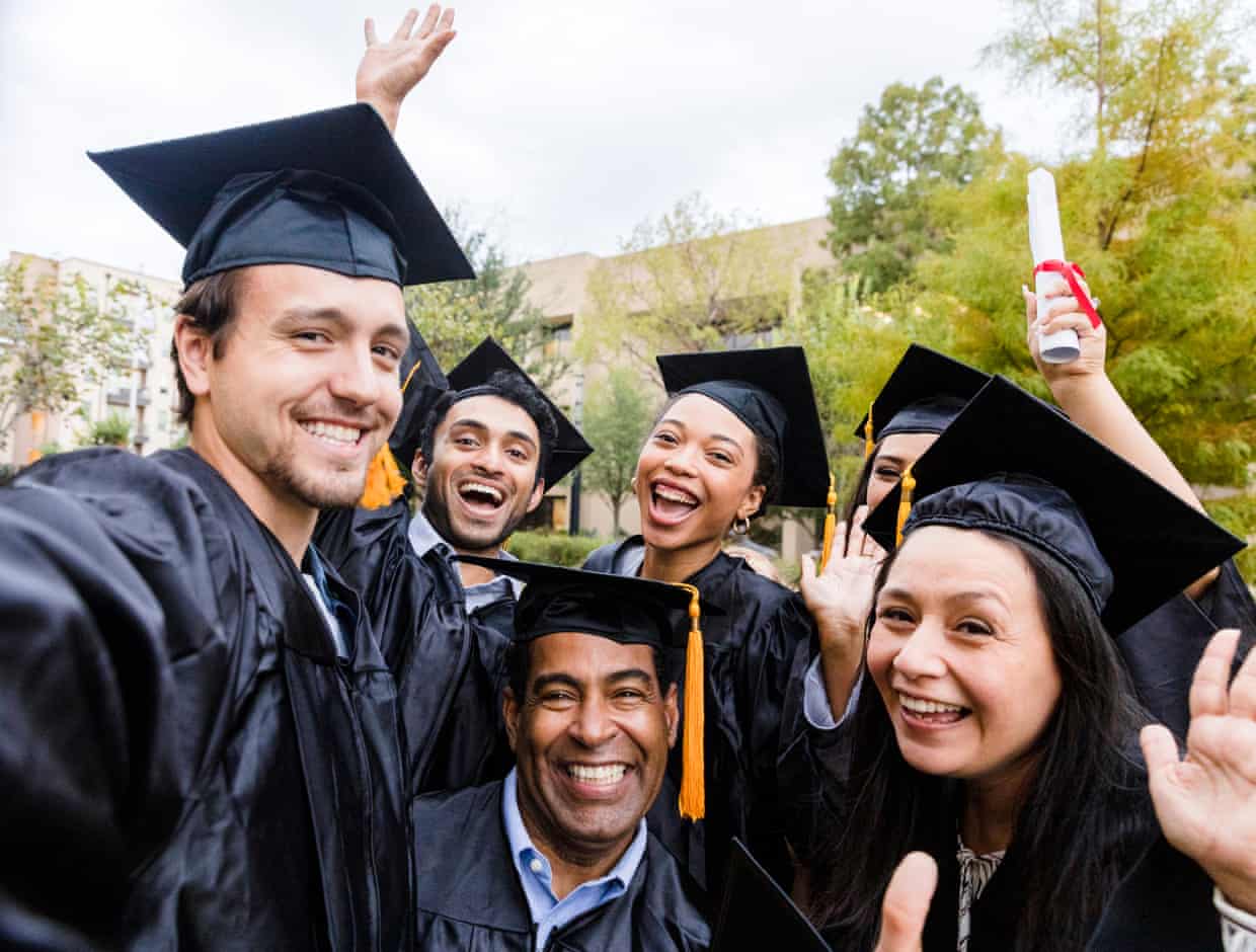 A group of university students celebrating with their certificates