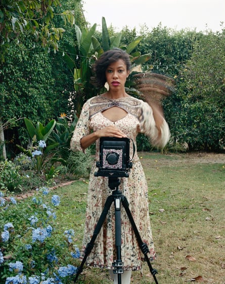 a woman stands behind a camera