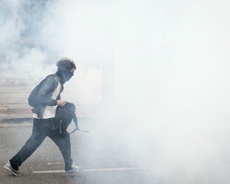 A student walks in a cloud of tear gas smoke as part of a student blockading protest near the Couffignal secondary school, in Strasbourg.