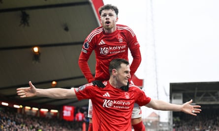 Neco Williams leaps on to the shoulders of Chris Wood