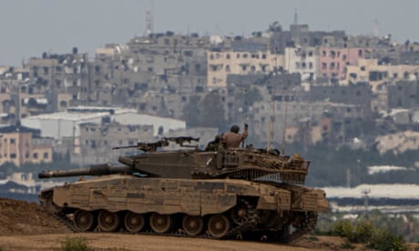 An Israeli soldier in a tank on the border with Gaza