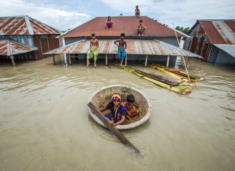 Bangladeshis escape floods in a makeshift raft.