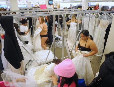 people trying on dresses