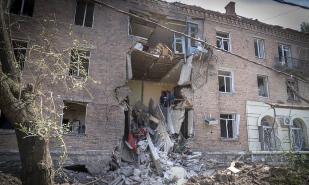 People salvage some of their belongings from a building damaged in a Russian rocket attack in Bakhmut, Ukraine