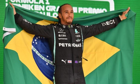 Lewis Hamilton celebrates on the podium after winning at Interlagos