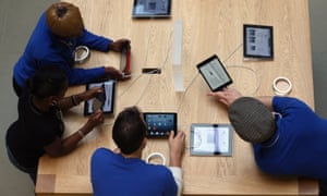 Apple staff use iPads at a store in central London