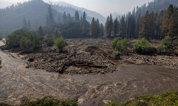 brown mucky river flowing through a charred landscape