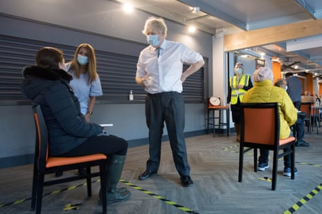 British prime minister Boris Johnson meets staff and patients at Barnet FC’s ground, The Hive, which is being used as a coronavirus vaccination centre, in north London, Britain, on 25 January, 2021.