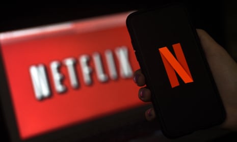 A phone with the Netflix logo in front of a TV with the Netflix logo