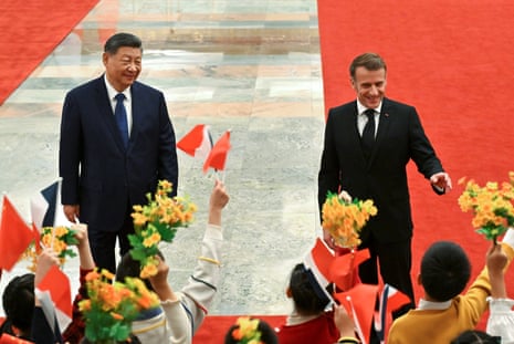 France’s president Emmanuel Macron gestures towards children next to China’s president Xi Jinping (L) during a welcome ceremony at the Great Hall of the People in Beijing.