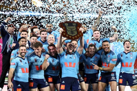 Isaah Yeo lifts the Origin shield for New South Wales.