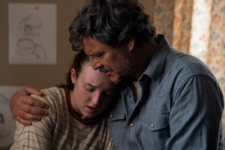 Bella Ramsey being hugged around her shoulders by Pedro Pascal in an emotional scene from the film