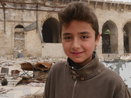 Fourtenn-year-old Yamin Saeed hangs out with his friends in the ruins.