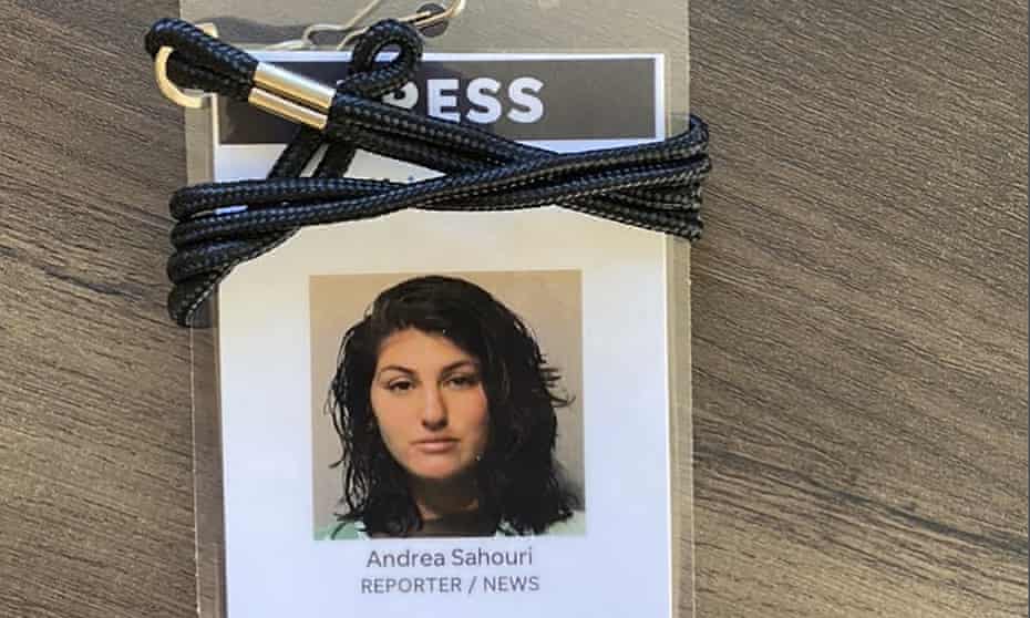 A press badge for Des Moines Register reporter Andrea Sahouri features her jail booking photo from her 31 May 2020 arrest while covering a Black Lives Matter protest.