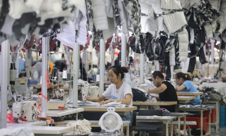 Workers produce coats in a factory in Nantong, Jiangsu province, China