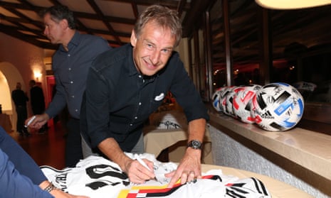 Jürgen Klinsmann signs a West Germany shirt, as worn by the team in winning the 1990 World Cup, in Italy last October.