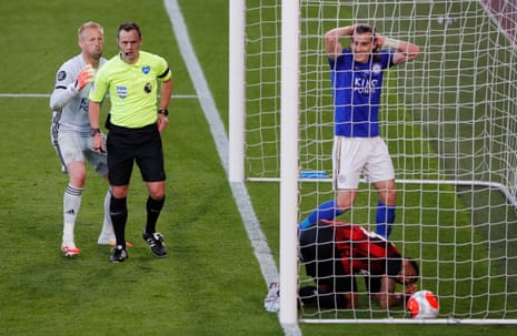 Leicester City’s Kasper Schmeichel appeals to referee Stuart Attwell before he sends off Leicester City’s Caglar Soyuncu.