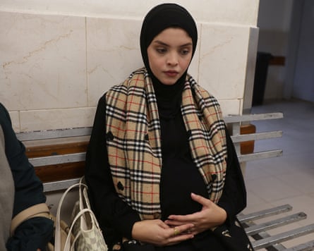 Pregnant Palestinian woman Rawaa Abu Al-Reesh sits at a clinic at Nasser Hospital