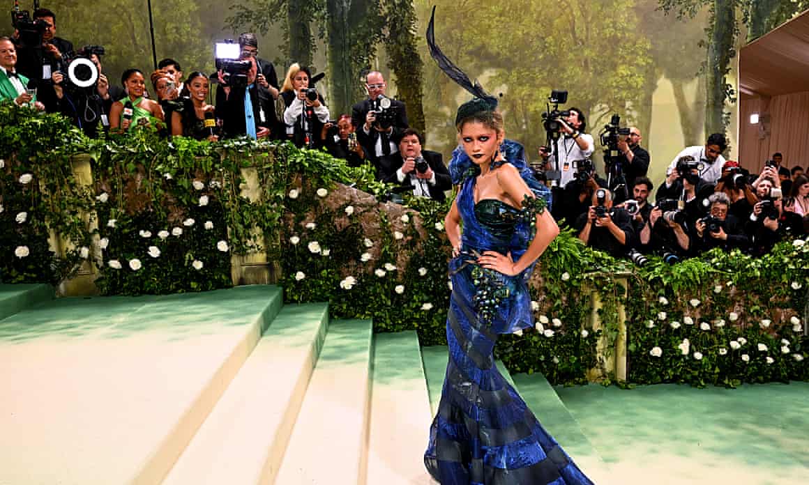 Zendaya posing for the cameras in a blue dress