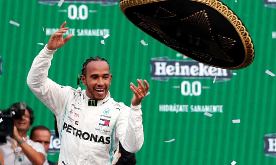Lewis Hamilton celebrates winning the race by throwing his sombrero high in the air.