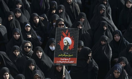 At a protest in Tehran in 2016, an Iranian woman holds up a poster showing Sheikh Nimr al-Nimr, a prominent opposition Saudi cleric who was executed by Saudi Arabia