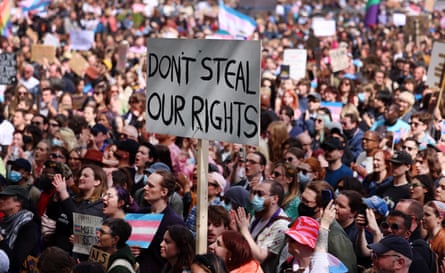 ‘Don’t steal our rights’. Others hold trans rights flags