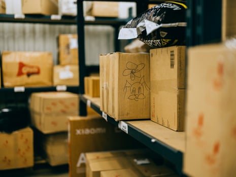 Cardboard boxes, one with hand-drawn doodles, on shelves